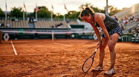 Joueur de tennis épuisé sur court terre battue après échange intense